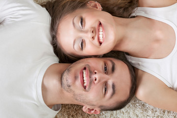 young couple lying on the carpet