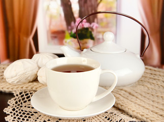 cup of tea with scarf on table in room