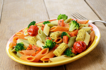 Pasta penne salad with broccoli, carrot, corn, and tomatoes