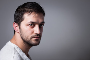 Obraz premium Young handsome man with serious expression