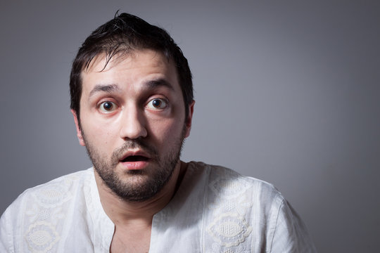 Young bearded man with astonished expression