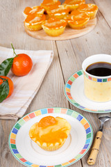 Fresh baked mini clementine cheesecakes in muffin forms