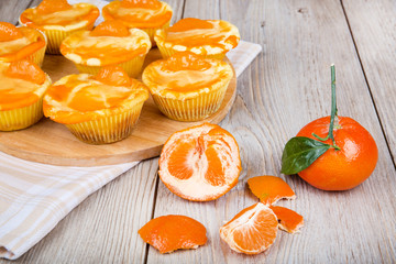 Fresh baked mini clementine cheesecakes in muffin forms