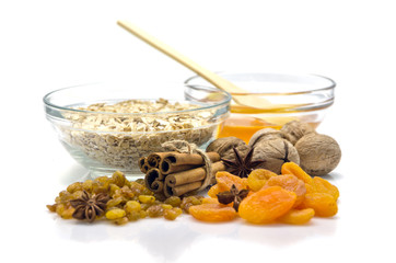 oatmeal in a glass bowl and dried fruits and honey