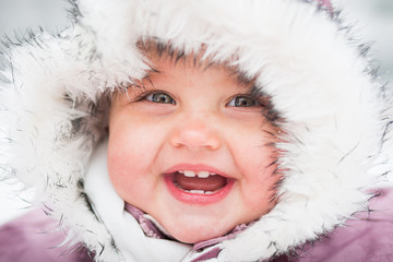 Happy baby on the winter background