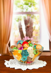 Dried oranges, wicker balls and other home decorations in glass