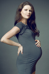 Expecting mother with long dark hair.