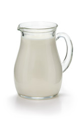 Jug with fresh milk on a white