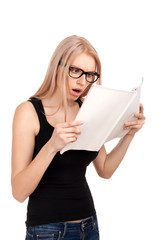 Shocked girl reading womens magazine