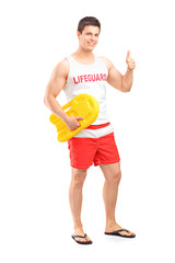 Full length portrait of a happy lifeguard on duty giving a thumb