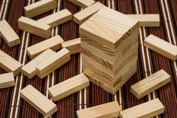 Wooden blocks tower and block spread around