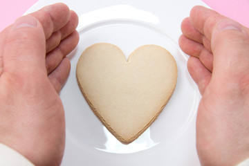 Love concept - hands around heart