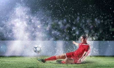 Foto op Canvas voetballer die de bal slaat © Sergey Nivens