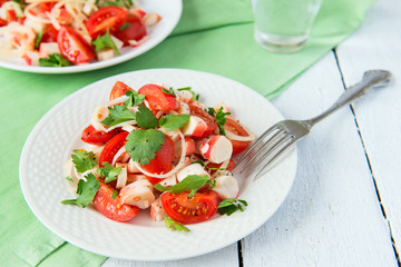 Salad from crabmeat sticks, tomatoes and parsley