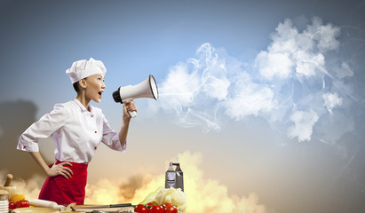 Asian female cook holding megaphone