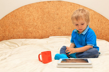 boy with digital tablet at home