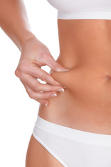 woman pinches fat on the belly, isolated on white