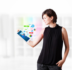 Young woman looking at modern tablet with colourful technology i
