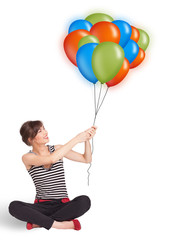 Young woman holding colorful balloons