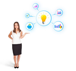 Young woman presenting light bulb with colorful graphs and diagr