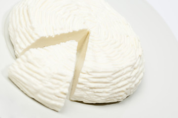 Fototapeta na wymiar cheese made ​​with cow's milk, isolated on white background