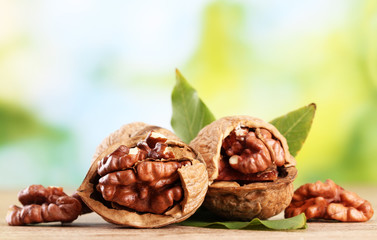 walnuts with green leaves, on green background