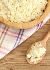 cottage cheese in bowl on  wooden table