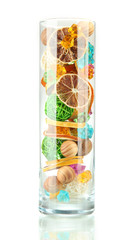 Dried oranges, wicker balls and other home decorations in glass