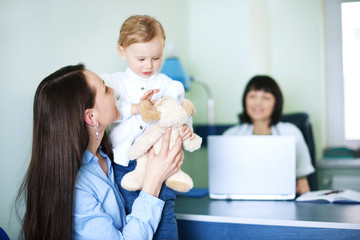 Mother with her daughter at doctors office