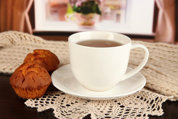 cup of tea with scarf on table in room