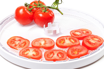 Fototapeta premium Ripe tomato on food dehydrator tray