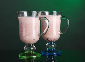 Cream cocktails on dark green background