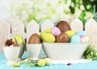 Composition of Easter and chocolate eggs on natural background