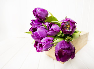 purple tulips on a  white wooden table