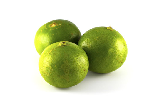 Green lemons and fresh ripe lemon isolated on white background.