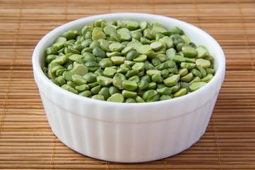 Green dry peas in white ceramic cup