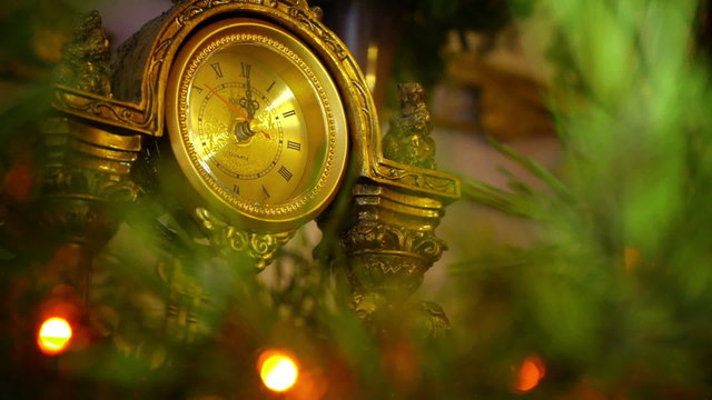 The arrows of the antique clock at midnight on New Year's.