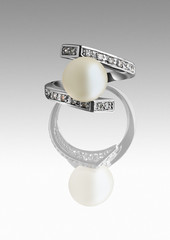Ring with pearl and diamonds on grey