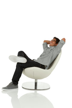 Young adult relaxing in a chair