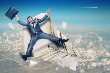 Businessman on stack of paperwork