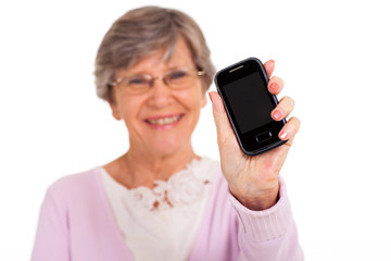 senior woman showing message on cell phone