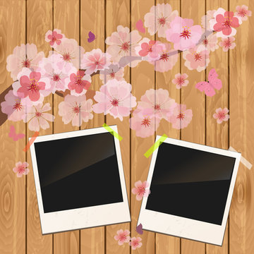 photo frame on wooden texture with cherry flowers