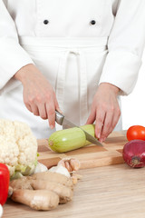 Woman chef chops vegetables for cooking