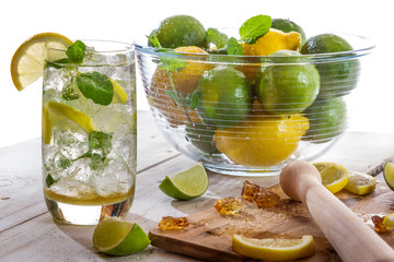 Cold drink with citrus fruit on white background