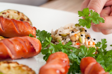Woman chef puts vegetables on a plate
