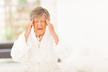 senior woman feeling headache at home