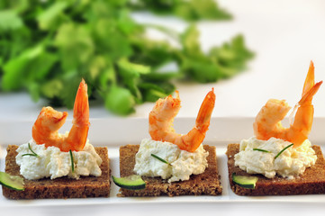 canapes rye bread with ricotta cheese and shrimps