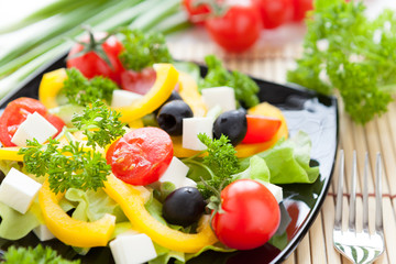 Fresh vegetable salad with feta in a vase