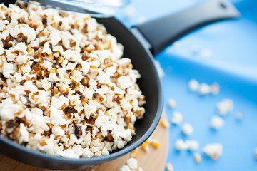 popcorn in a pan on a blue cloth