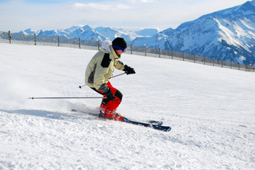 male skier moving down a ski track